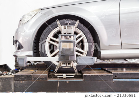 Tire clamped with aligner undergoing wheel align 21330681
