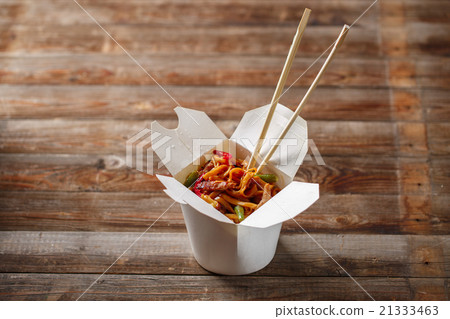 Noodles with pork and vegetables in take-out box 21333463