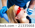 dentist treats teeth 21335668