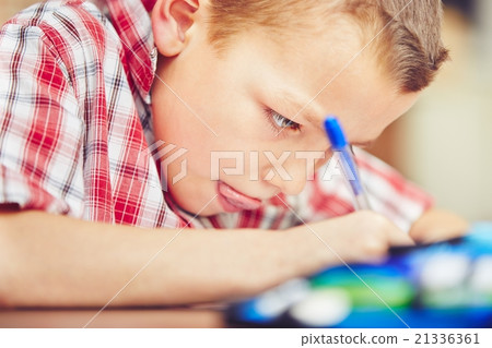 Boy is doing homework Boy is doing homework 21336361