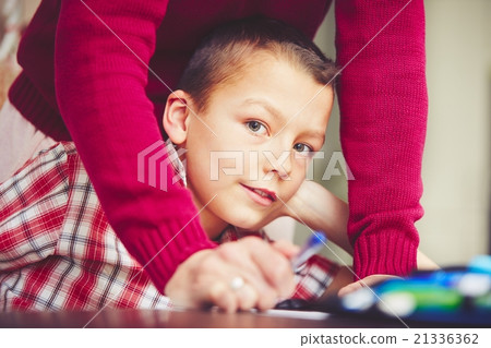 Boy is doing homework 21336362