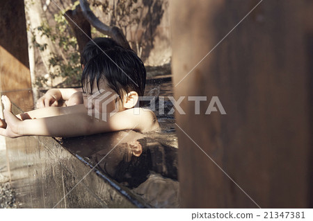 Child entering outdoor bath 21347381
