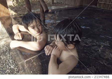 Child entering outdoor bath 21347466