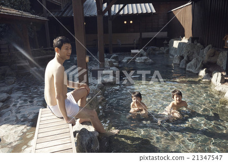 Parent and child entering outdoor bath 21347547