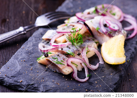 Sliced herring on a black slate plate Sliced herring on a black slate plate 21348000