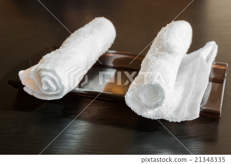 white roll napkins on wooden plate. white roll napkins on wooden plate. 21348335