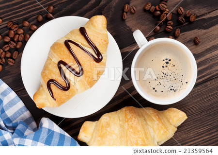 Fresh croissants and coffee Fresh croissants and coffee 21359564