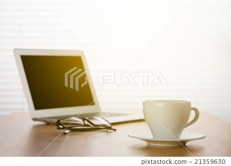 Office workplace with with laptop and coffee cup 21359630