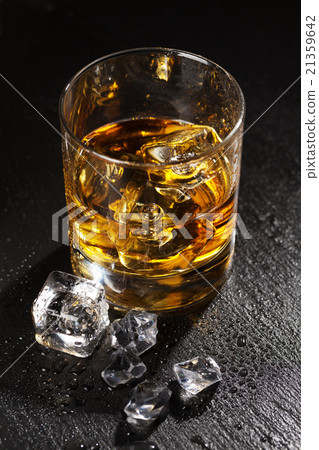 Glass of whiskey with ice 21359642