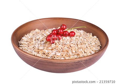 Oatmeal in a bowl with red currants isolated 21359710