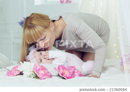 Mother is kissing her little daughter Mother is kissing her little daughter 21360084