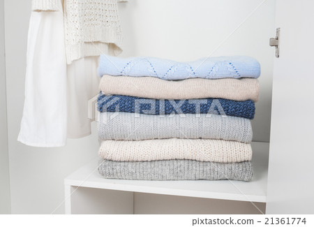 Stack of knitted warm woolen clothes 21361774