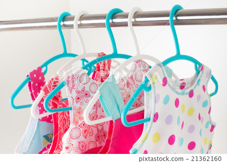 row of little girl dresses hanging on coat hanger row of little girl dresses hanging on coat hanger 21362160
