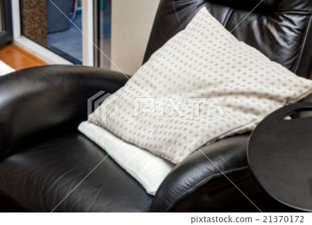 Pillows in black leather comfort chair 21370172