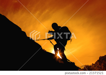 Silhouette of mountaineer and sunset. Silhouette of mountaineer and sunset. 21371521