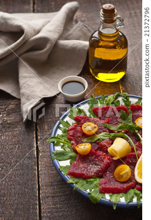 Carpaccio on the white plate on the wooden table Carpaccio on the white plate on the wooden table 21372796