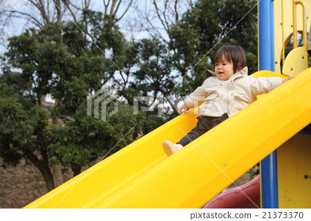 Baby playing on the slide (1 year old child) Baby playing on the slide (1 year old child) 21373370