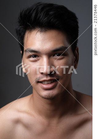 Asian man portrait with no makeup show his real skin in grey background - soft focus 21378446