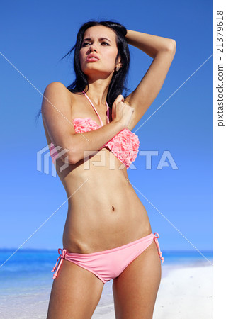 woman sunbathing in pink bathing suit woman sunbathing in pink bathing suit 21379618