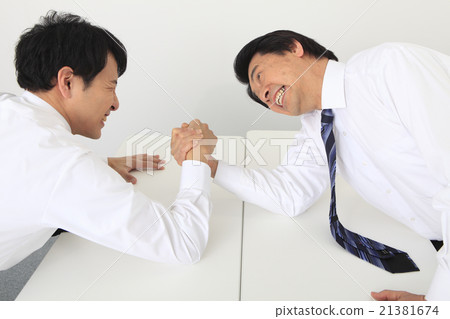 A businessman to arm sumo wrestling A businessman to arm sumo wrestling 21381674
