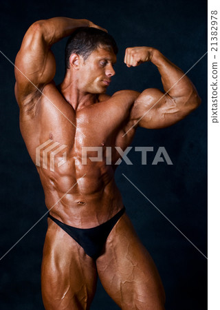Young athletic man showing his muscles Young athletic man showing his muscles 21382978