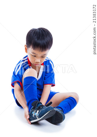 Soccer player tying shoe for competition.Full body Soccer player tying shoe for competition.Full body 21383172