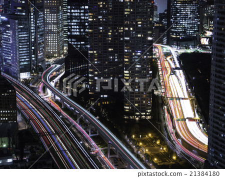 Buildings in central Tokyo and light traces of cars and trains running in capital high 21384180