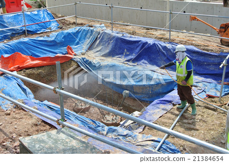 Workers spraying anti termite chemical treatment 21384654