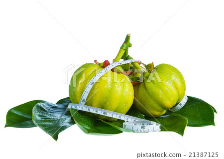 Garcinia cambogia with measuring tape, isolated. 21387125