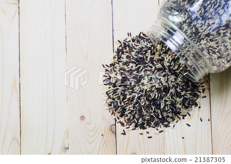 Pile of rice on wood background Pile of rice on wood background 21387305