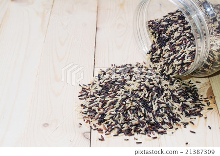 Pile of rice on wood background Pile of rice on wood background 21387309