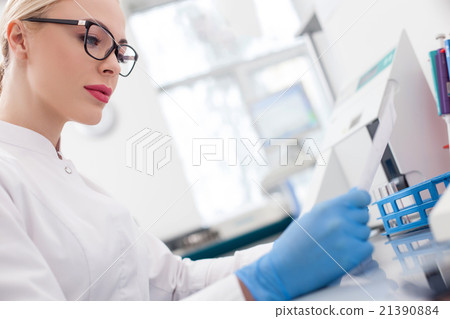 Beautiful female researcher is working with papers Beautiful female researcher is working with papers 21390884