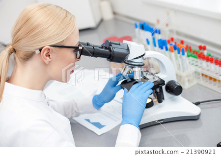 Skillful young laboratory assistant is making Skillful young laboratory assistant is making 21390921