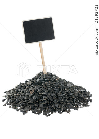 Heap of sunflower seeds with pointer for your text Heap of sunflower seeds with pointer for your text 21392722