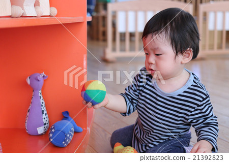 Baby playing with toy ball 21392823