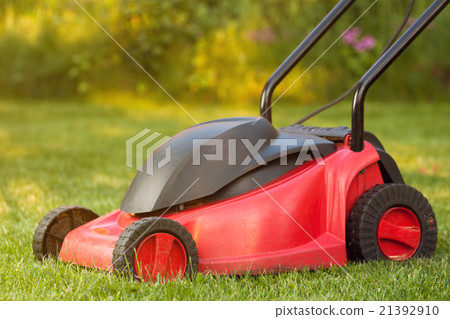 Lawnmower on lawn grass Lawnmower on lawn grass 21392910