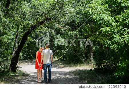 young pretty couple in the green summer park young pretty couple in the green summer park 21393940