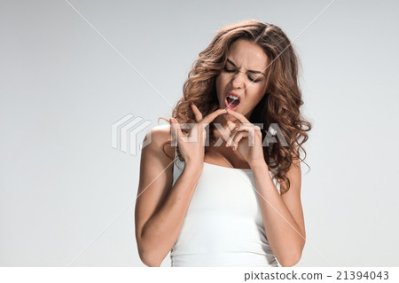 The young woman's portrait with bored emotions The young woman's portrait with bored emotions 21394043