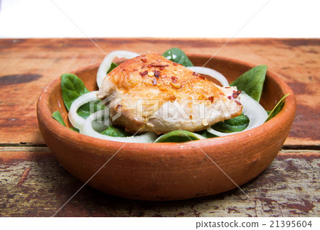 grilled chicken is served in a clay pot 21395604