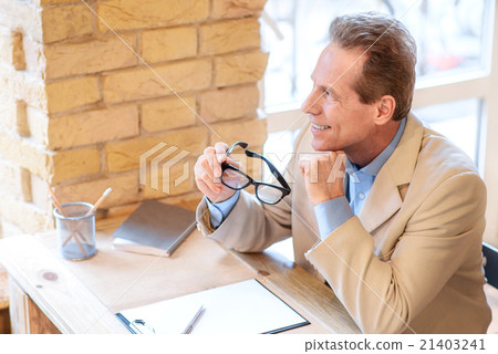 Positive man sitting in the cafe Positive man sitting in the cafe 21403241
