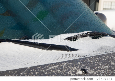 Ice and snow cover windshield and car hood 21407725