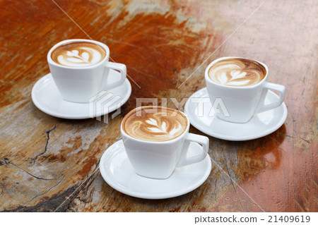 cup of latte coffee on wooden table. 21409619