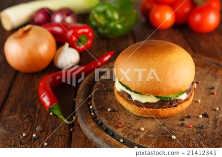 Meet and cheese burger at wooden desk Meet and cheese burger at wooden desk 21412341