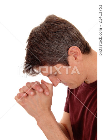 Praying young man in profile. Praying young man in profile. 21413753