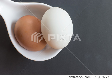 Brown and white eggs in white bowl 21419774