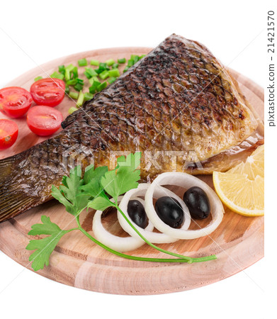 Fried carp tail with olives and onion. 21421570
