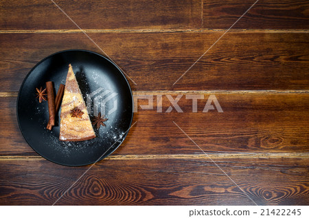 Piece of cake with cinnamon and anise on the side 21422245