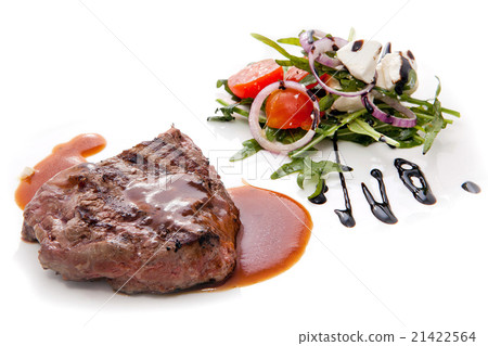 Juicy grilled steak served with a greek salad. 21422564