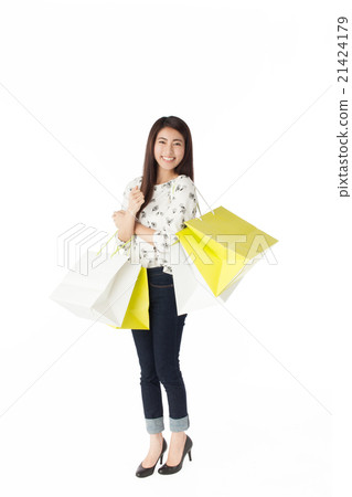 A woman holding a bomb shop bag full of both hands A woman holding a bomb shop bag full of both hands 21424179