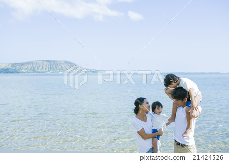 Parent and child walking along the beach 21424526